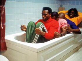 Still from Cool Runnings showing four men in a bathtub pretending to be in a bobsled