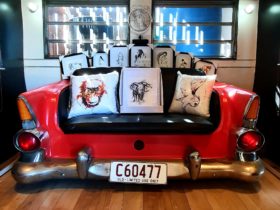 photo of red car seat with artworks sitting on it