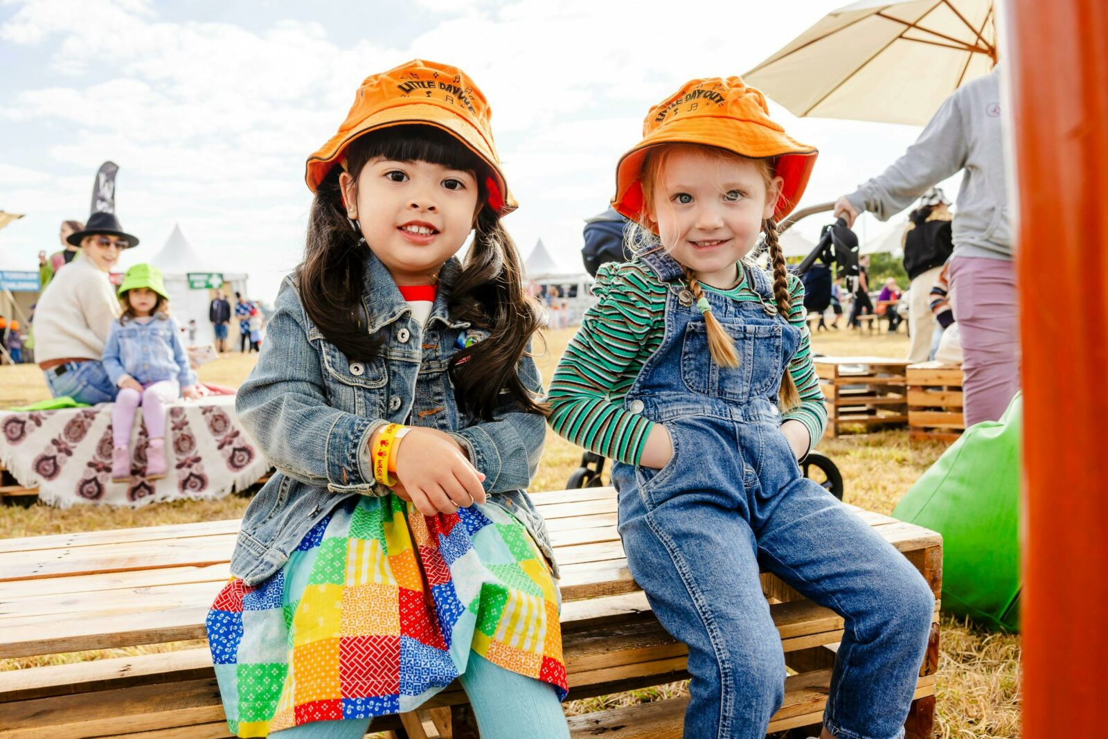 Kids sitting on crates at a festival