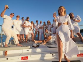 Group dressed in white on deck