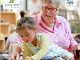 Aged care resident and child playing together at playgroup