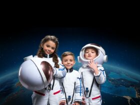 Three kids are posing in the astronauts costumes.