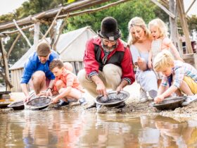 Family panning for gold with costumed digger